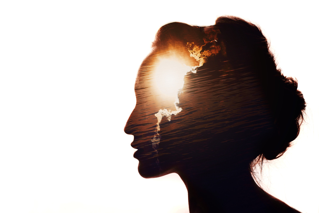 Multiple exposure portrait of a woman. The sun behind the clouds. Emotional intelligence concept.